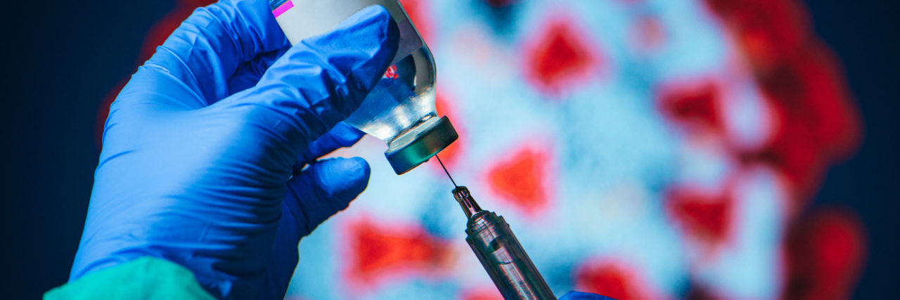 Will the COVID-19 Vaccine Have Side Effects? Doctor drawing up solution from vaccine bottle and filling syringe injection for patient vaccination in medical clinic, Coronavirus in background