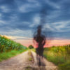 a person jogging on a rural road