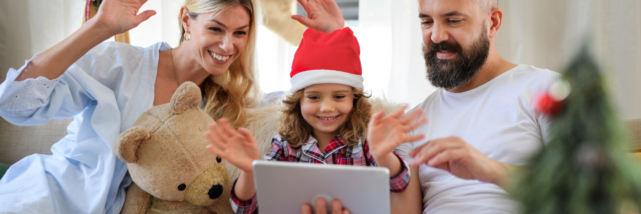 Pandemic Holidays May Be Easier for Families of Medically Complex Kids Family with small daughter indoors at home at Christmas.