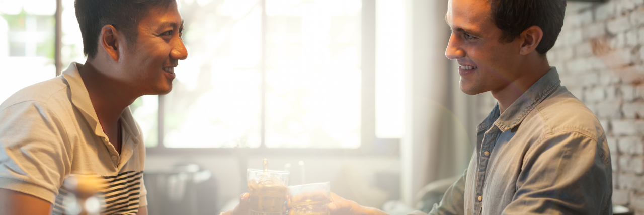 Dating as a Gay Man With a Sometimes-Visible Disability Two men on a date at a restaurant.