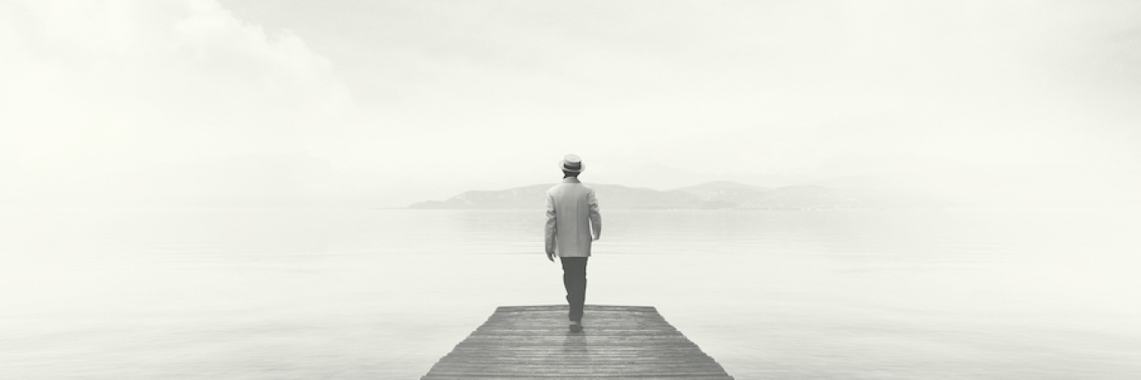 A Metaphor for Depression; It's Just Like Walking Through a Fog Man walking on a boardwalk in the fog