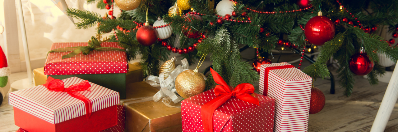 Why Visiting Family for the Holidays Is Difficult as a Wheelchair User Gifts under Christmas tree.