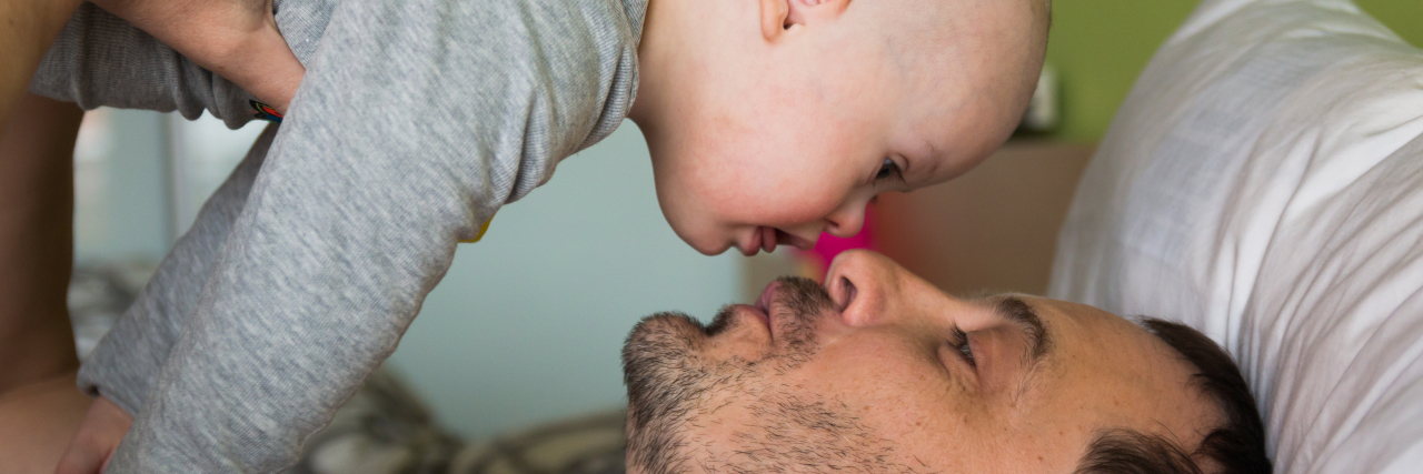 Letter to the New Dad of a Baby With Down Syndrome Cute baby boy with Down syndrome playing with dad.