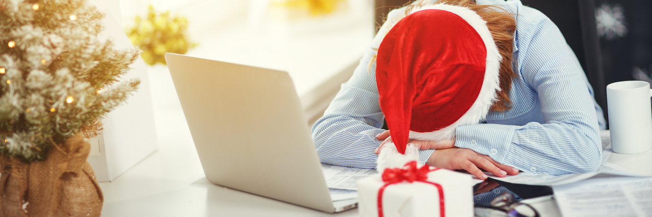 You Don’t Have to Do It All This 2020 Holiday Season Tired woman wearing Santa hat sleeping at laptop.