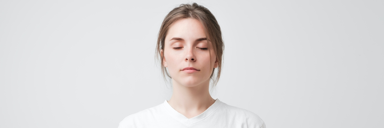 Challenging Expectations About Cognitive Behavioral Therapy (CBT) Woman with her eyes closed on a white background