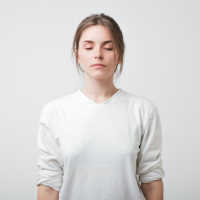 Woman with her eyes closed on a white background