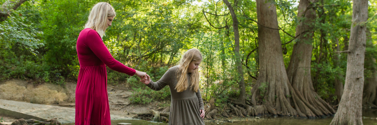 To My Daughter With a Limb Difference: I See You Jaime ad her daughter on stepping stones in the water.