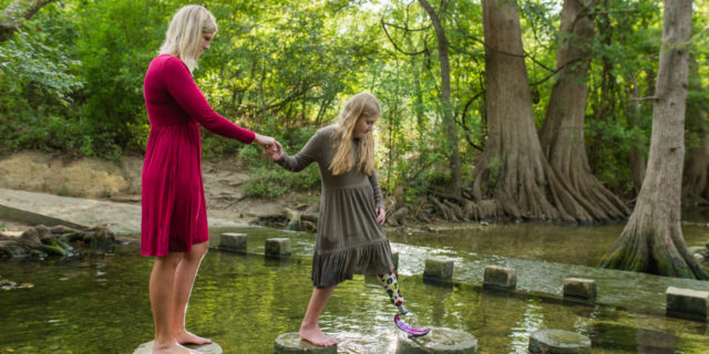Jaime ad her daughter on stepping stones in the water.