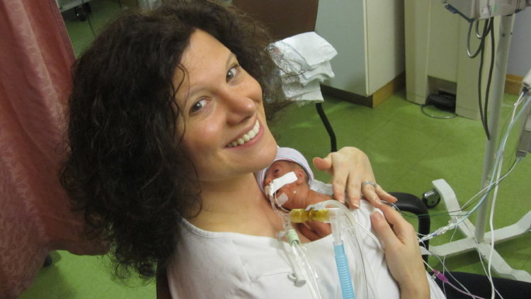 Jennifer holding her premature baby in the NICU.