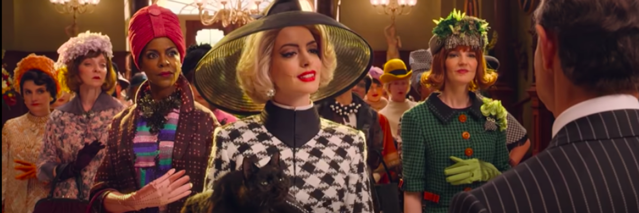 Anne Hathaway wearing a hat and black-and-white checkered jacket in "The Witches"