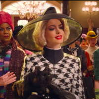 Anne Hathaway wearing a hat and black-and-white checkered jacket in "The Witches"