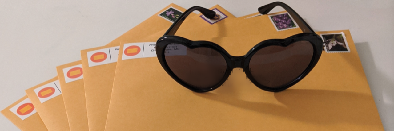 A group of letters with sunglasses on top