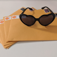 A group of letters with sunglasses on top