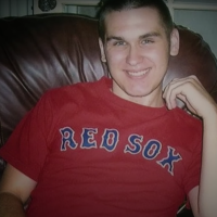 A photo of CJ, the author's son, wearing a Red Sox shirt and smiling