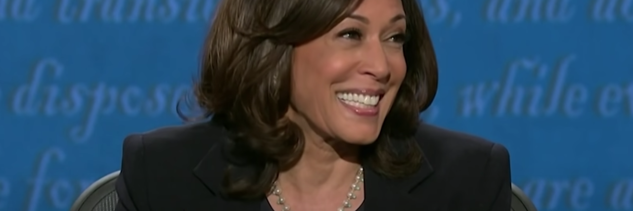 screenshot of Kamala Harris during vice presidential debate, smiling off camera