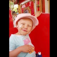 a young girl with a feeding tube smiling