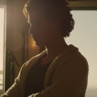 screenshot of shawn mendes documentary from Netflix, showing the musician silhouetted by a window at sunset