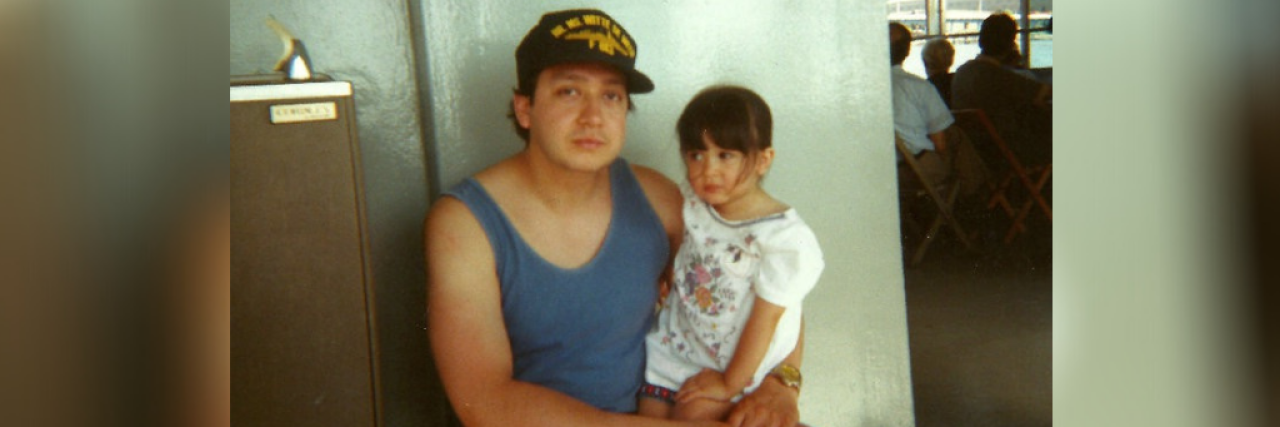 Accepting That My Father's Suicide Is Not My Fault Image of contributor as young child sitting on her child's lap