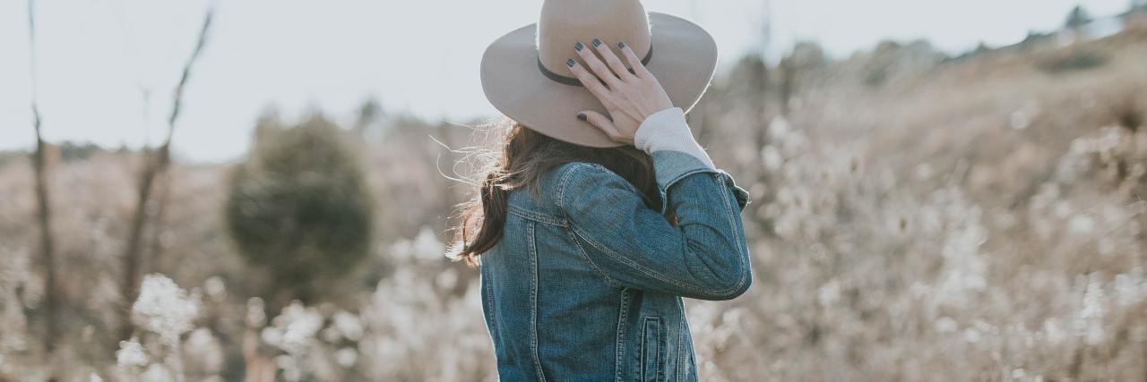 Are Introverts More Likely To Have Social Anxiety? photo of woman alone in a field, facing away from camera