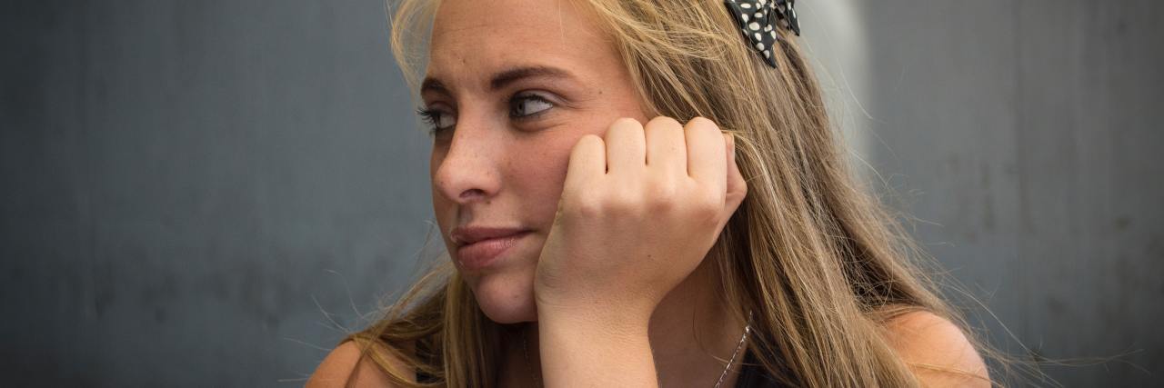Practical Self-Care to Improve Mental Health During COVID-19 photo of young woman resting head on hand lost in thought