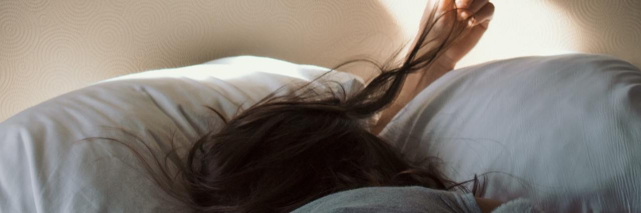 What Depression Is Like in the Morning A woman lying in bed, unable to get up
