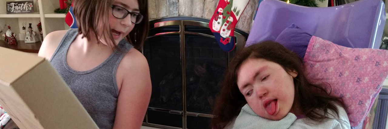 Gift Guide for Teens With Intellectual and Developmental Disabilities Teen Julia enjoys opening holiday gifts with her sister Erica.