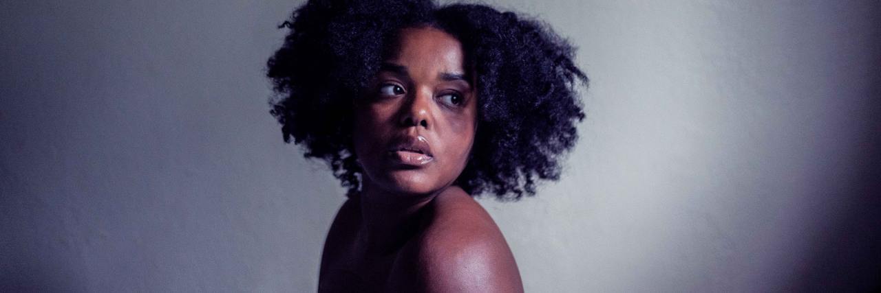 Feeling Unsafe After Election Day as a Black Woman With PTSD A black woman looking over her shoulder