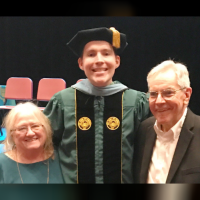 Kerry with his parents at his graduation.