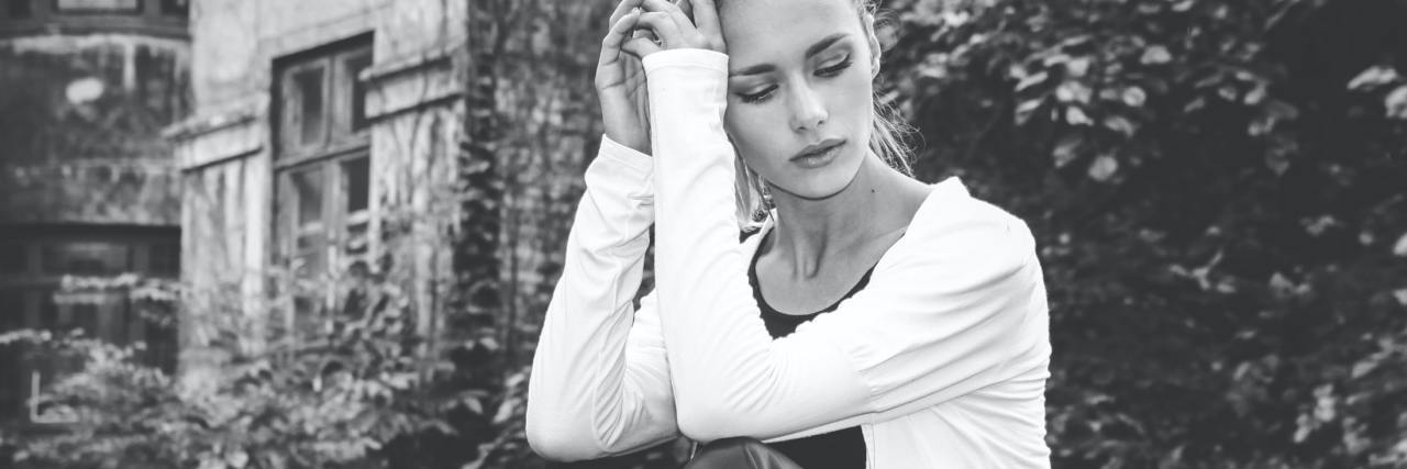 How to Take Care of Your Body and Mind: Mental Fatigue During COVID-19 black and white photo of woman looking tired while sitting outside