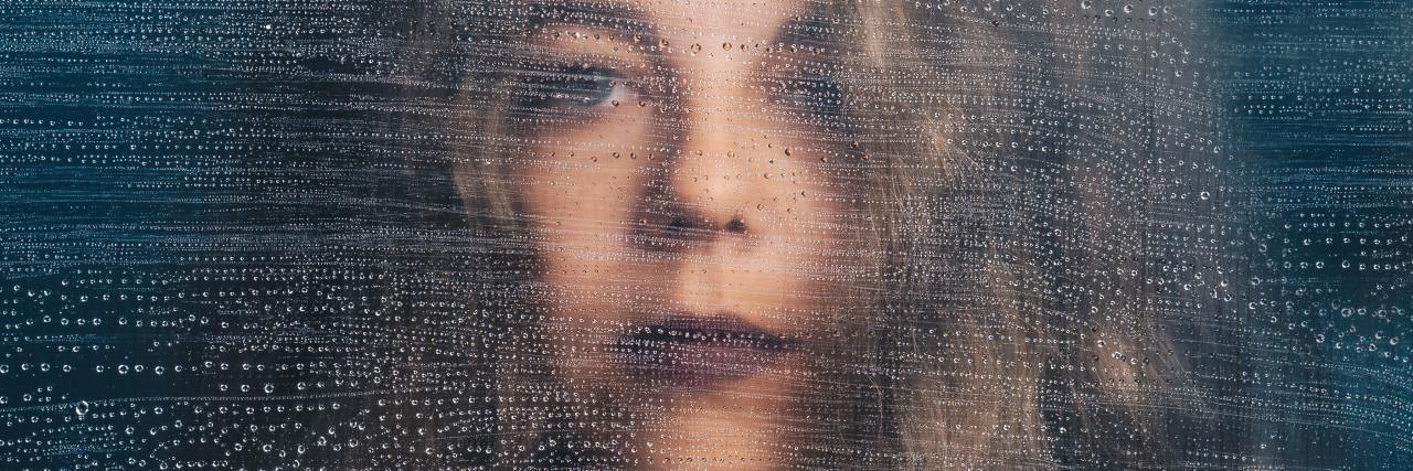 Self-Harm Can Happen at Any Age, Not 'Just' to Teenagers photo of woman staring into camera with distorted effect across her face