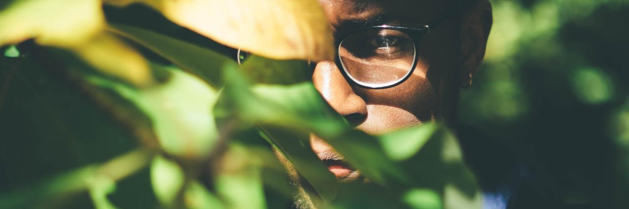5 Tips for Recovering Your Life After Your Manic Episode man hiding behind leaves