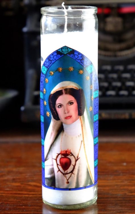 photo of a candle with the image of Carrie Fisher dressed as Princess Leia from Star Wars and as a saint