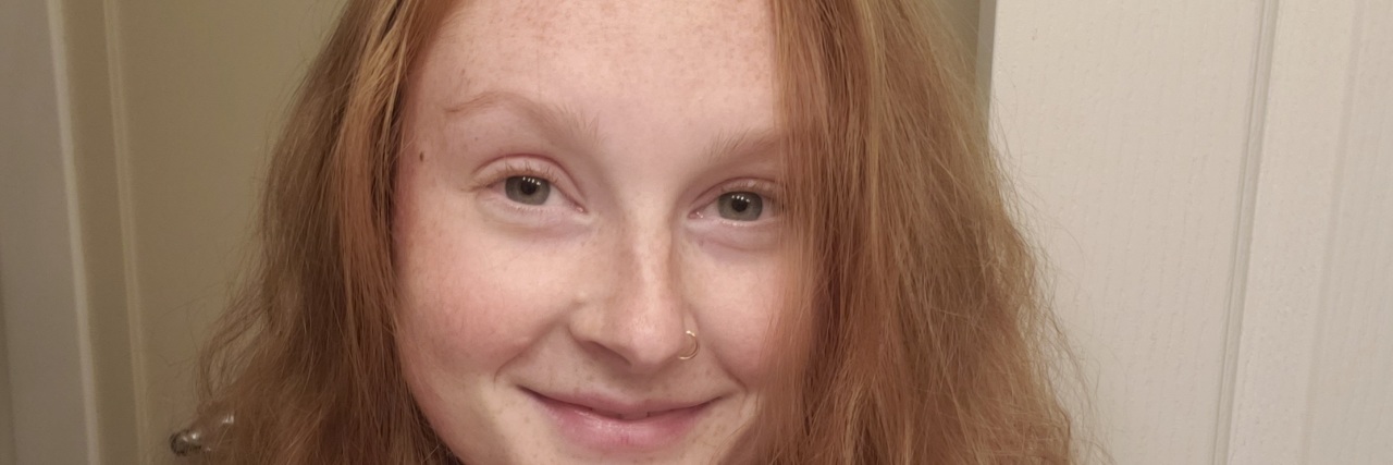 Accepting Vulnerability in Life With Chronic Illness Photo of woman with red hair smiling at camera