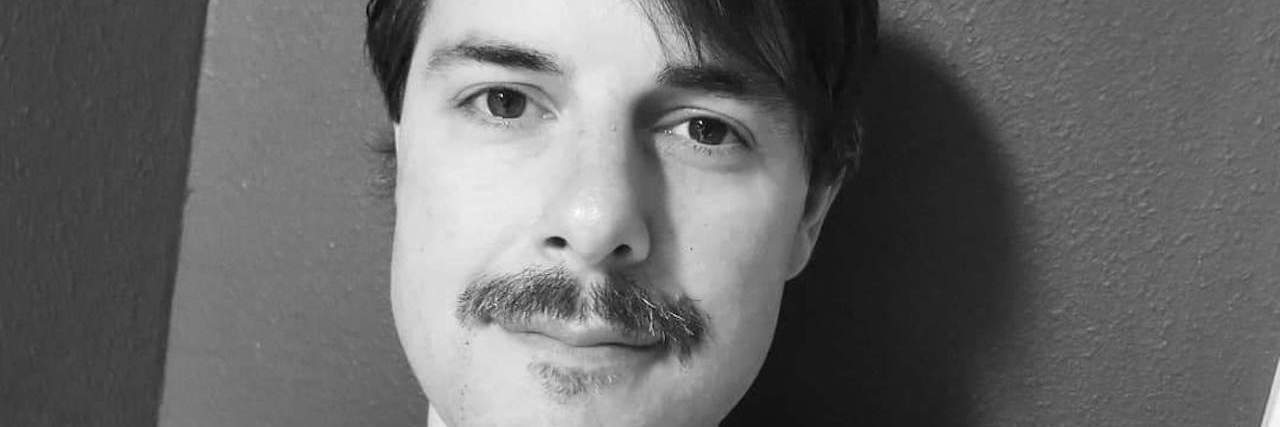 Life With Multiple Sclerosis in the Year of COVID the author, smiling, with his mustache