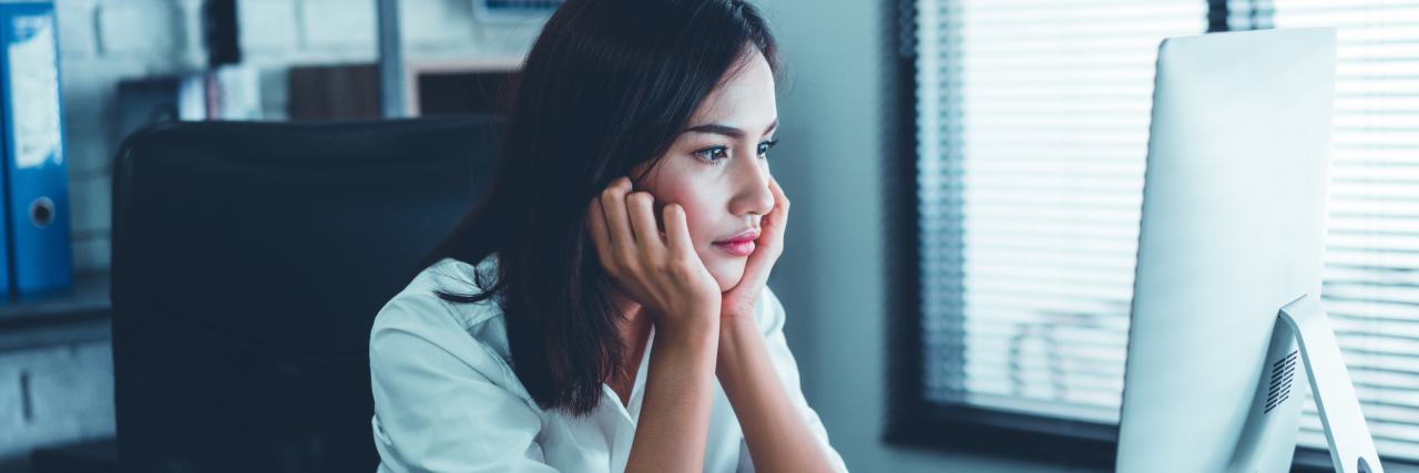 Chronically Capable Helps People With Chronic Illness Find Jobs Woman sleepy at work in front of computer screen.