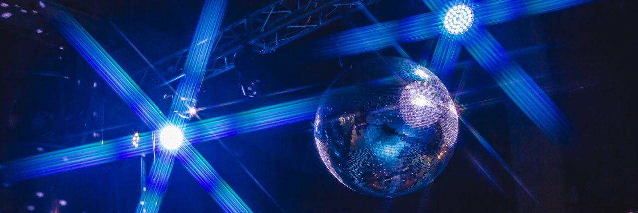 Virgin Media Removes Harmful Ad After Epilepsy Advocates Speak Out Blue background disco ball with disco lights.