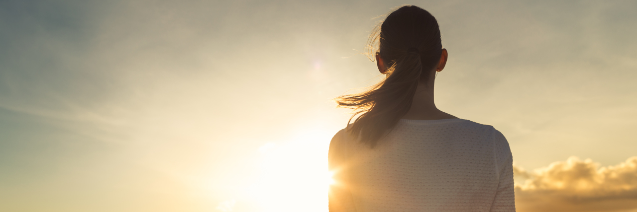 Living Life After Bad Things Happen a young woman looking toward the sun