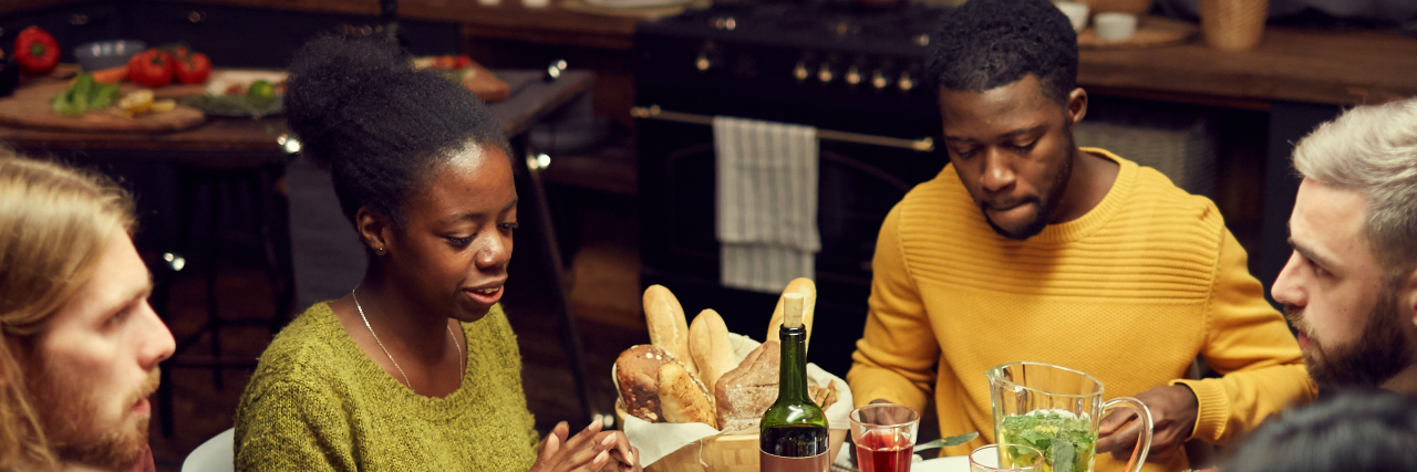 Managing Mental and Physical Health as a Black Man This Holiday Season Black family at dinner