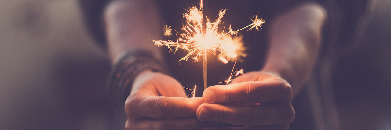 A woman holding a sparkler