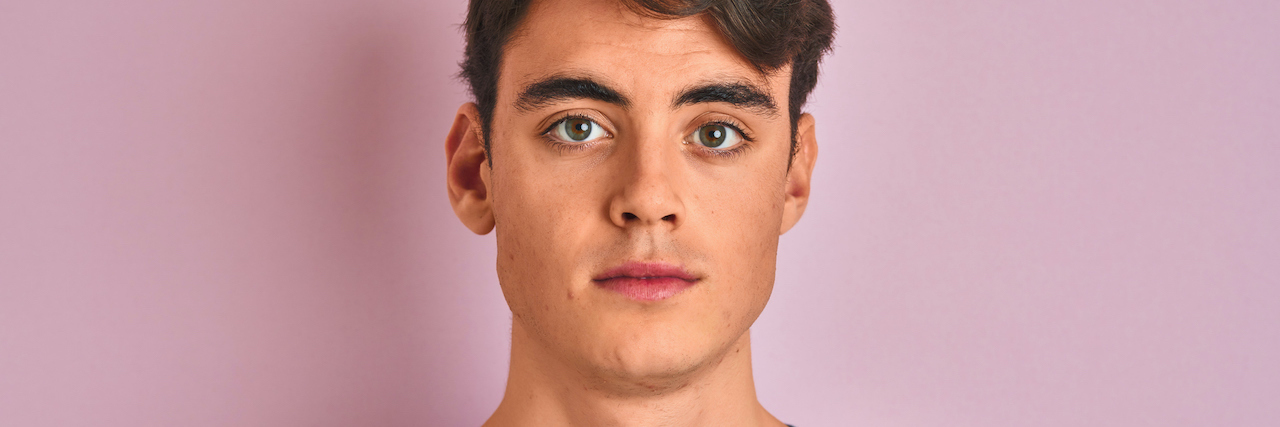 A Different Way to Think About Removing Mental Health Stigma A man looking forward against a plain background