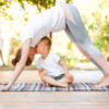 a mom and young son doing yoga on a mat