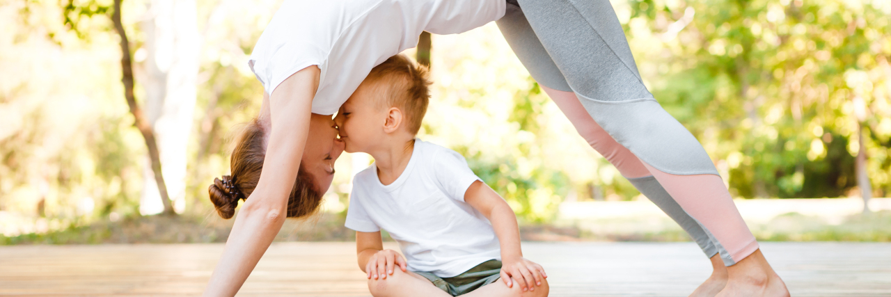 Becoming More Selfish to Be a Better Parent a mom and young son doing yoga on a mat