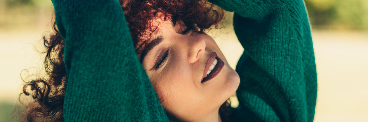 My Health Highs and Lows of 2020 A woman outside, with her hands up