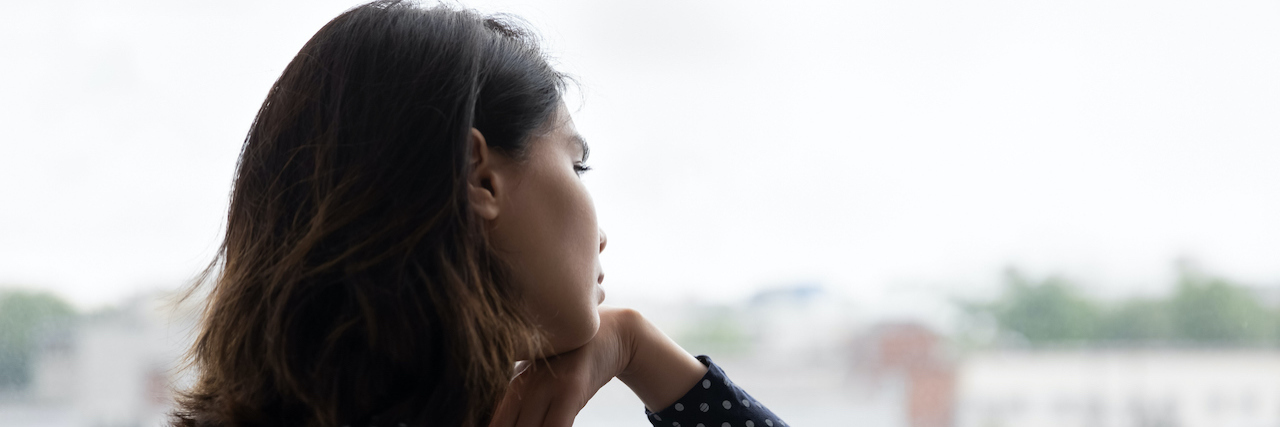 Being Stuck in a Toxic Home Due to the Pandemic Hurts My Mental Health Young woman gazing out window