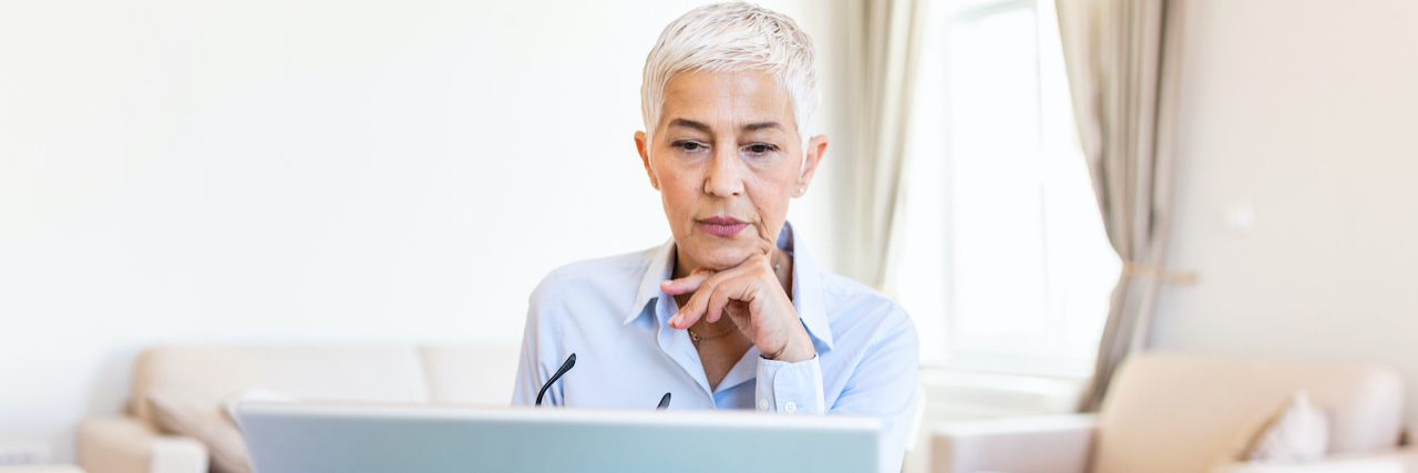The Importance of Writing About Losing My Daughter to Suicide Portrait of a woman in front of her laptop