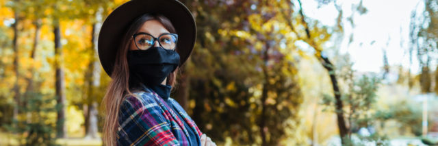 Stylish woman wears protective mask outdoors during coronavirus covid-19 pandemic.