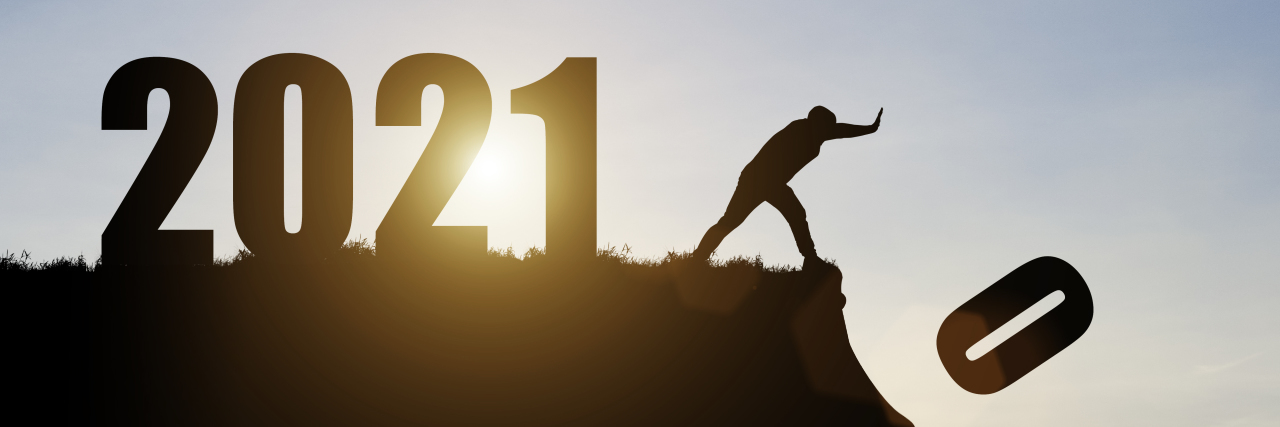 Man pushes number zero off the cliff to 2021.