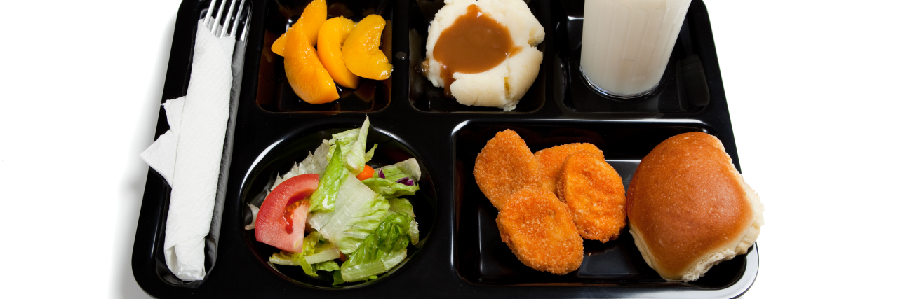 Why I Thought Constant Abdominal Pain Was Normal as a Kid lunch served on a black tray