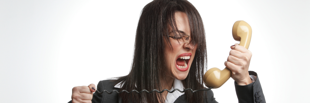 a woman is yelling into a phone