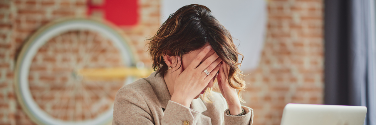 When Chronic Pain Threatens to Halt Your Career woman getting a Headache In Office